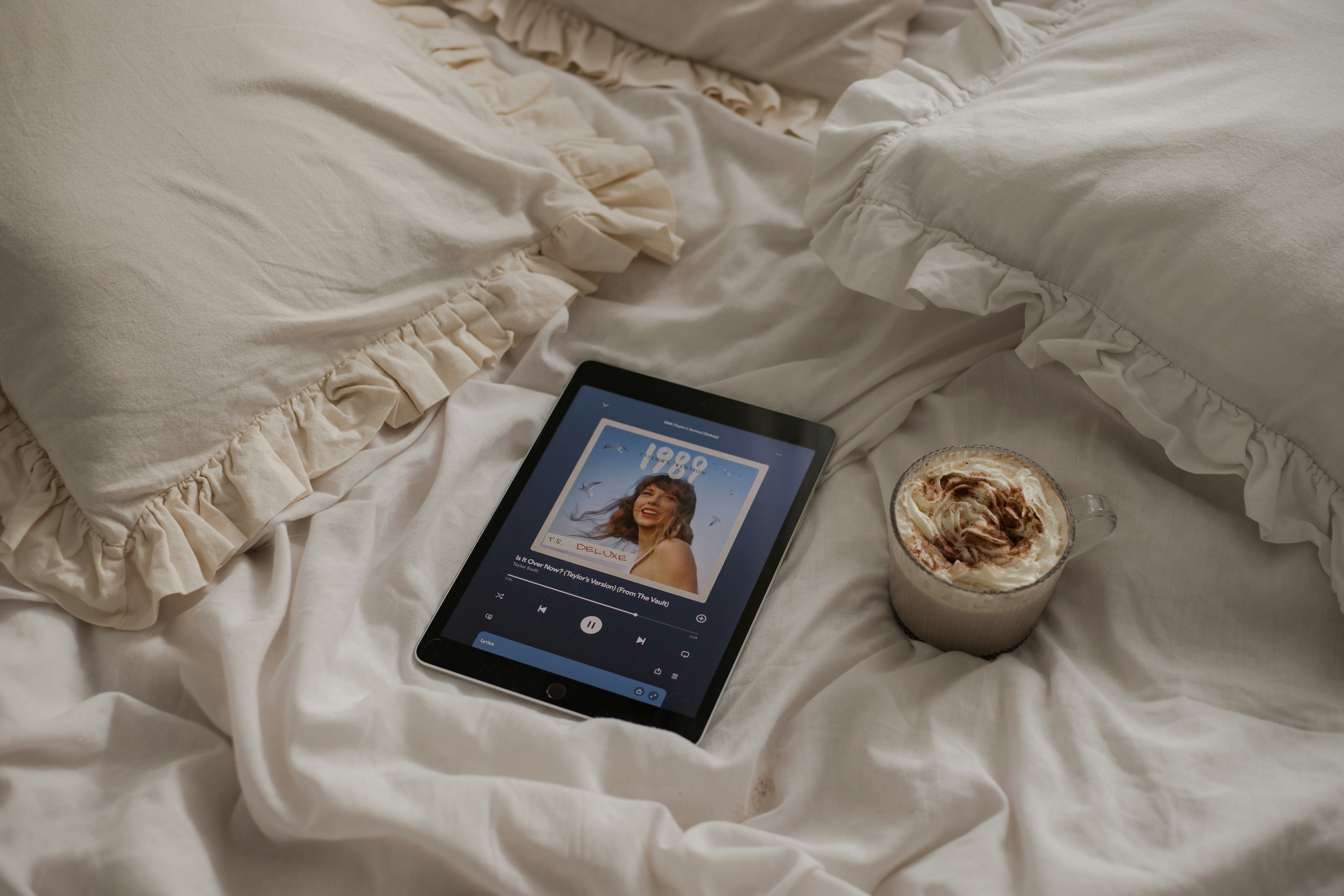 taylor swift (taylor's version) on ipad on bed with warm drink